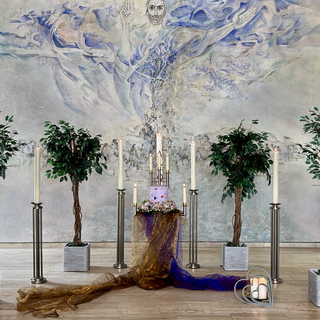 A ceremonial setting with candles and flowers
